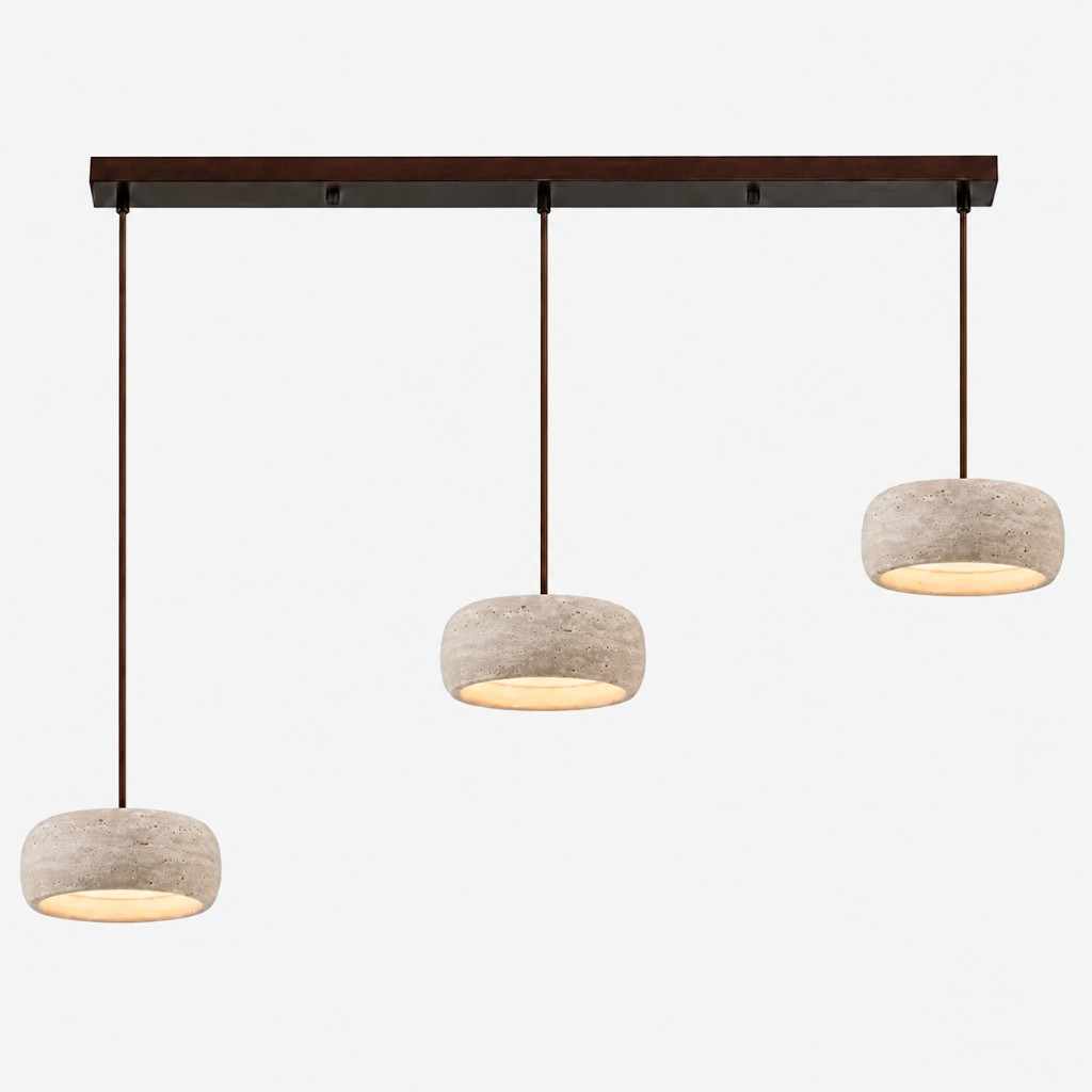 Three smaller cream travertine rounded pendants on a dark bar