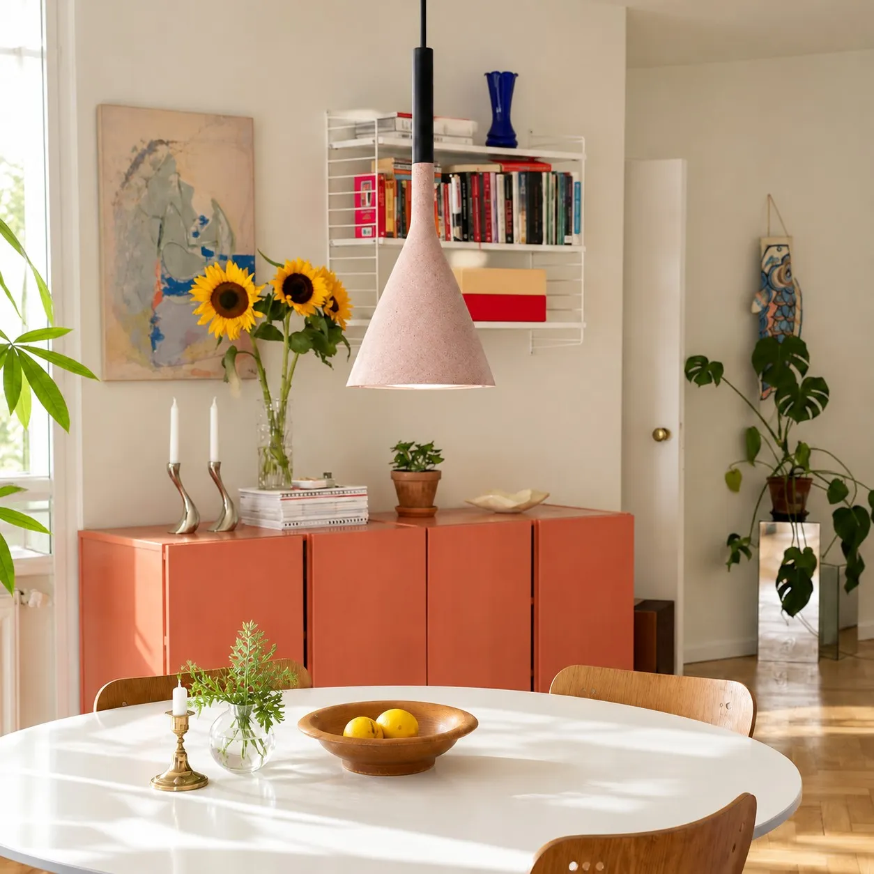Brick red conical pendant in a dining room