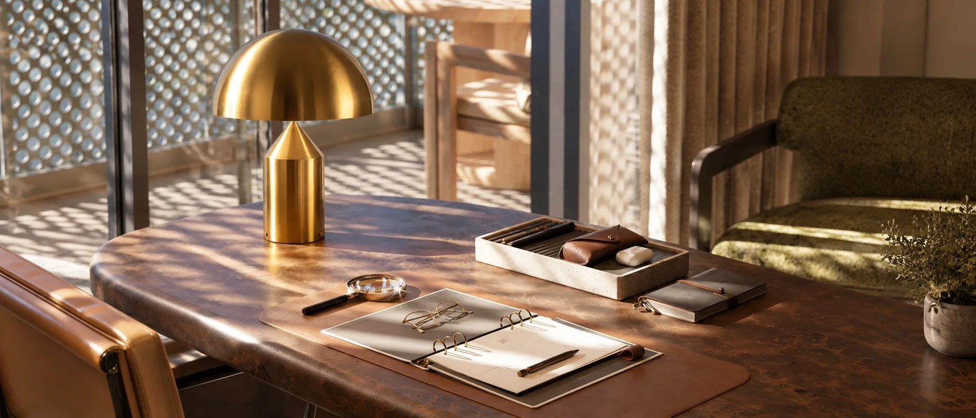 Gold HaloVell table lamp on a desk by a window